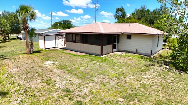 27193AND27197 Voyageur Dr, Punta Gorda, FL 33983 - rear view of property with a sunroom, a storage shed, an outdoor structure, and a lawn