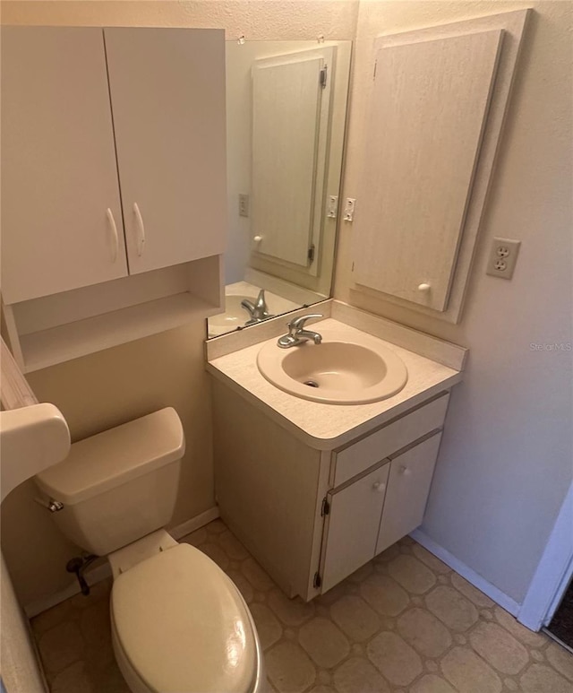 27193AND27197 Voyageur Dr, Punta Gorda, FL 33983 - bathroom featuring toilet, vanity, and baseboards