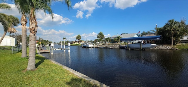 27193AND27197 Voyageur Dr, Punta Gorda, FL 33983 - dock area featuring boat lift, a water view, and a lawn