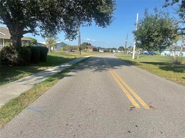 27193AND27197 Voyageur Dr, Punta Gorda, FL 33983 - view of asphalt road featuring sidewalks and a residential view