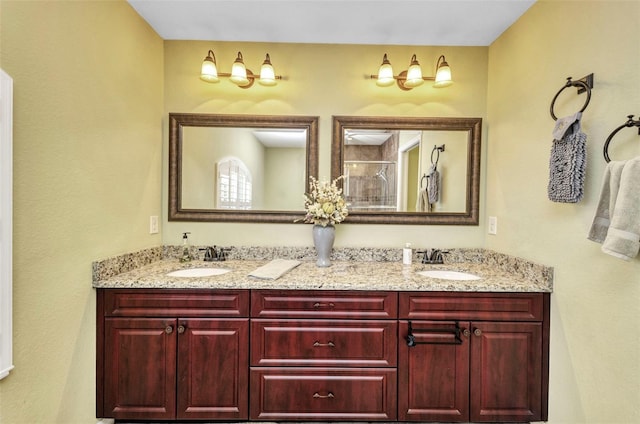 full bath with a shower stall and double vanity