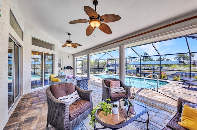 sunroom featuring a swimming pool, ceiling fan, and vaulted ceiling