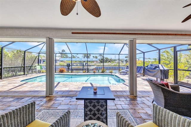 outdoor pool featuring ceiling fan, a patio area, and a lanai