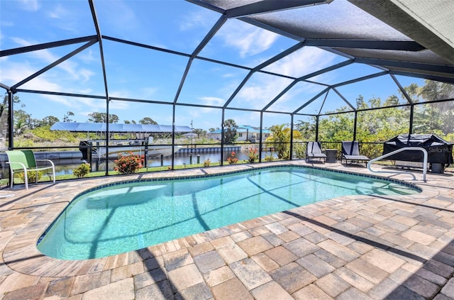 swimming pool with a patio, a water view, a grill, and glass enclosure