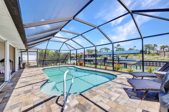 outdoor pool featuring a patio, a water view, glass enclosure, and a boat dock