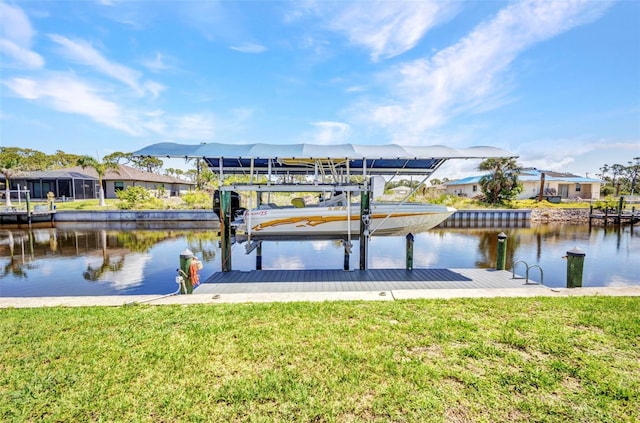 dock area with a water view, boat lift, a residential view, and a lawn