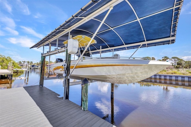 dock featuring boat lift and a water view