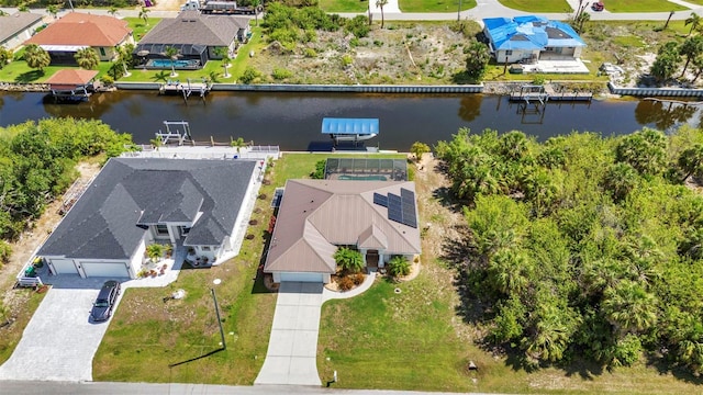 aerial view of residential area featuring a large body of water