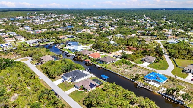 aerial view of residential area featuring a nearby body of water