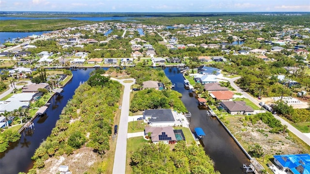 aerial view of residential area featuring a nearby body of water
