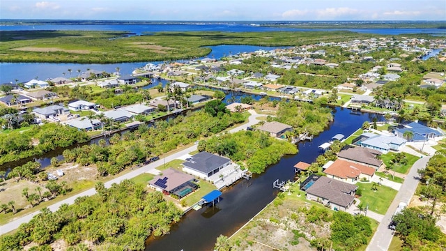 aerial view of residential area featuring a nearby body of water