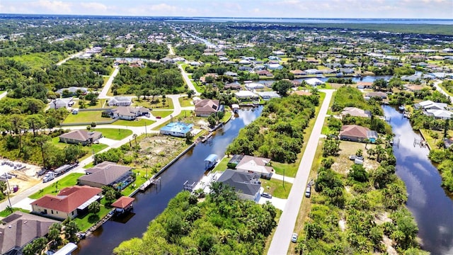 aerial perspective of suburban area featuring a nearby body of water