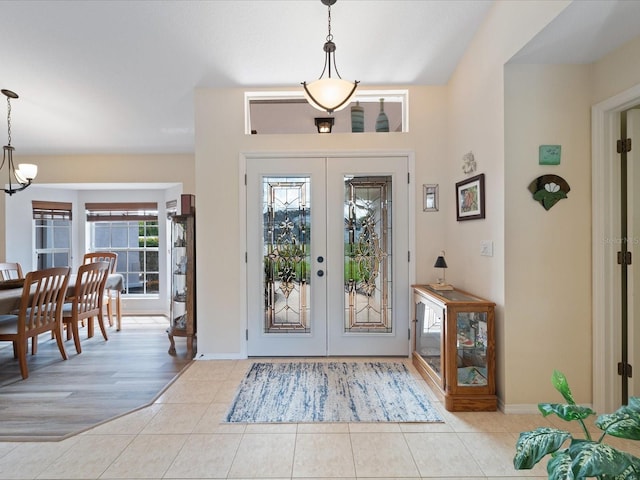 85 Long Meadow Ct, Rotonda West, FL 33947 - tiled entrance foyer featuring french doors, a chandelier, and baseboards