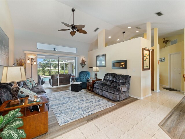 85 Long Meadow Ct, Rotonda West, FL 33947 - living room featuring ceiling fan, high vaulted ceiling, light tile patterned flooring, and a sunroom