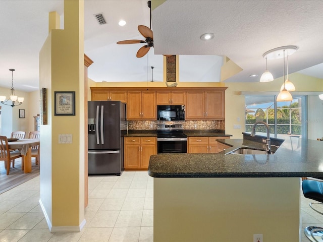 85 Long Meadow Ct, Rotonda West, FL 33947 - kitchen with refrigerator with ice dispenser, stainless steel electric range, black microwave, a sink, and light tile patterned floors