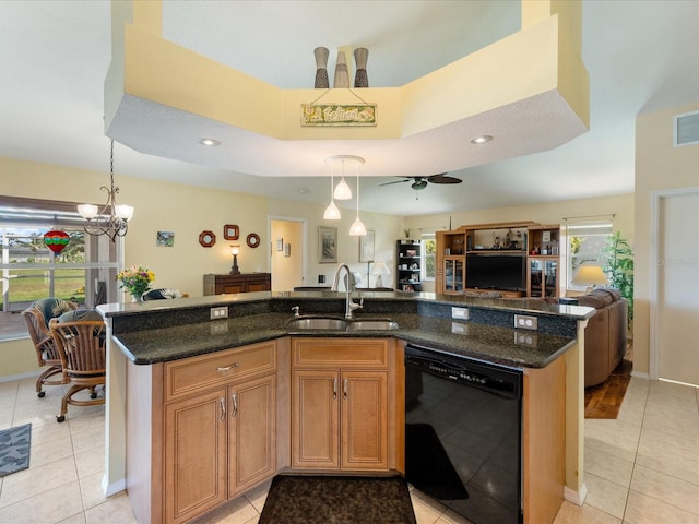 85 Long Meadow Ct, Rotonda West, FL 33947 - kitchen with black dishwasher, a sink, open floor plan, light tile patterned floors, and an island with sink