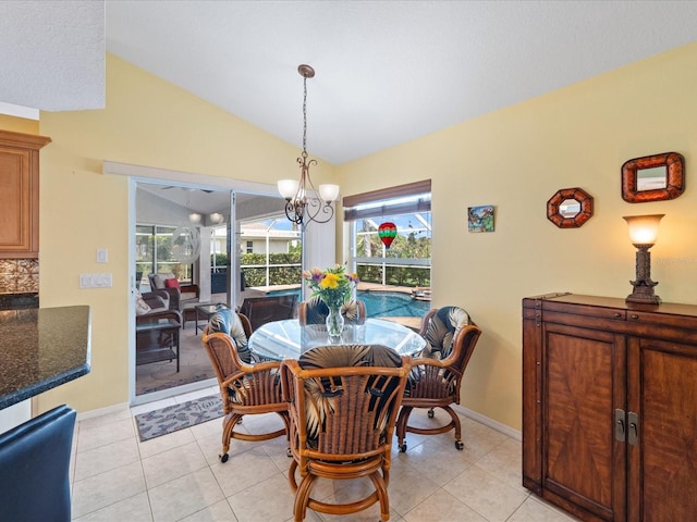 85 Long Meadow Ct, Rotonda West, FL 33947 - dining area with lofted ceiling, a chandelier, light tile patterned floors, and baseboards