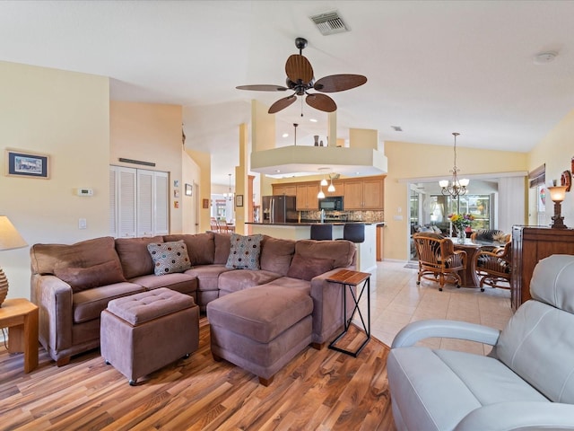 85 Long Meadow Ct, Rotonda West, FL 33947 - living area featuring ceiling fan, a chandelier, light wood-style flooring, and high vaulted ceiling