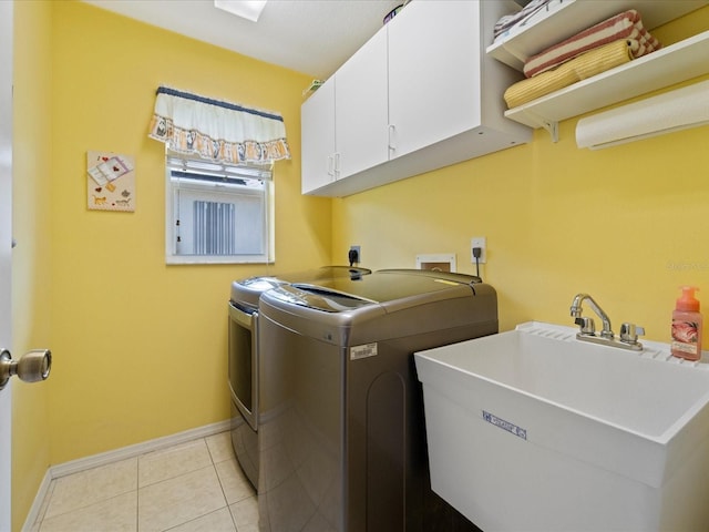 85 Long Meadow Ct, Rotonda West, FL 33947 - laundry room featuring cabinet space, washer and clothes dryer, baseboards, and light tile patterned floors