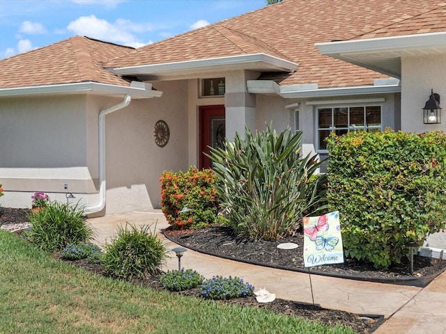 85 Long Meadow Ct, Rotonda West, FL 33947 - doorway to property with roof with shingles and stucco siding