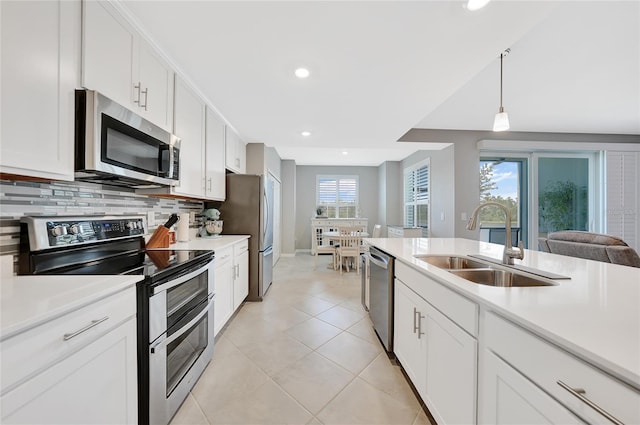 14271 Heritage Landing Blvd Unit 1516, Punta Gorda, FL 33955 - kitchen featuring appliances with stainless steel finishes, a sink, light countertops, recessed lighting, and white cabinets