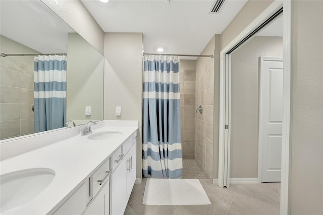 14271 Heritage Landing Blvd Unit 1516, Punta Gorda, FL 33955 - bathroom with a tile shower, double vanity, and tile patterned flooring