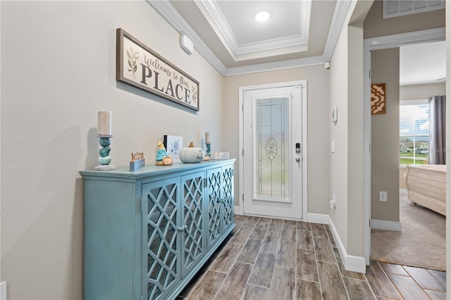 25308 Rupert Rd, Punta Gorda, FL 33983 - entrance foyer featuring ornamental molding, wood finished floors, a tray ceiling, and baseboards