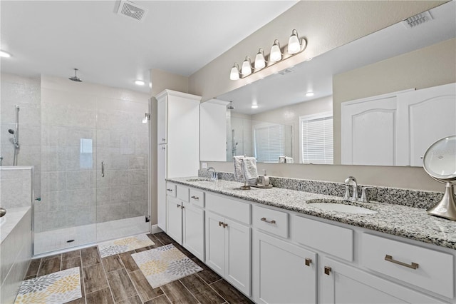 25308 Rupert Rd, Punta Gorda, FL 33983 - full bath with a stall shower, double vanity, and wood tiled floors