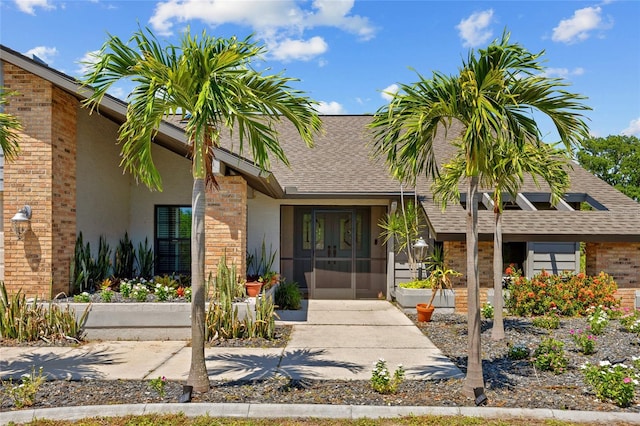 501 Fairmont Ter, Port Charlotte, FL 33954 - entrance to property with roof with shingles, brick siding, and stucco siding