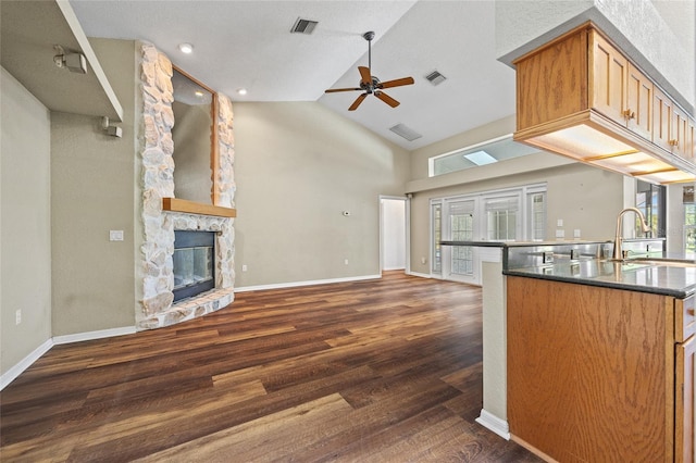 501 Fairmont Ter, Port Charlotte, FL 33954 - kitchen with a ceiling fan, a sink, open floor plan, a fireplace, and dark wood-style floors
