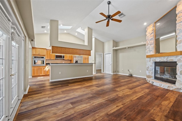 501 Fairmont Ter, Port Charlotte, FL 33954 - unfurnished living room featuring a fireplace, a skylight, ceiling fan, high vaulted ceiling, and dark wood finished floors