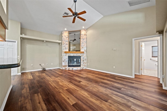 501 Fairmont Ter, Port Charlotte, FL 33954 - unfurnished living room with a ceiling fan, a fireplace, vaulted ceiling, wood finished floors, and baseboards