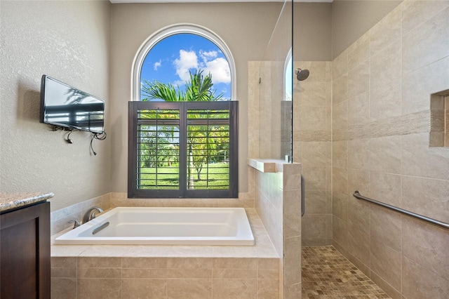 501 Fairmont Ter, Port Charlotte, FL 33954 - full bathroom with a garden tub, a tile shower, and a textured wall