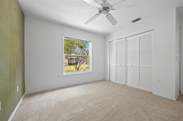 501 Fairmont Ter, Port Charlotte, FL 33954 - unfurnished bedroom with carpet flooring, a closet, a textured ceiling, a ceiling fan, and baseboards