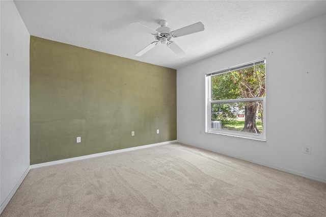 501 Fairmont Ter, Port Charlotte, FL 33954 - carpeted spare room with ceiling fan, baseboards, and a textured ceiling