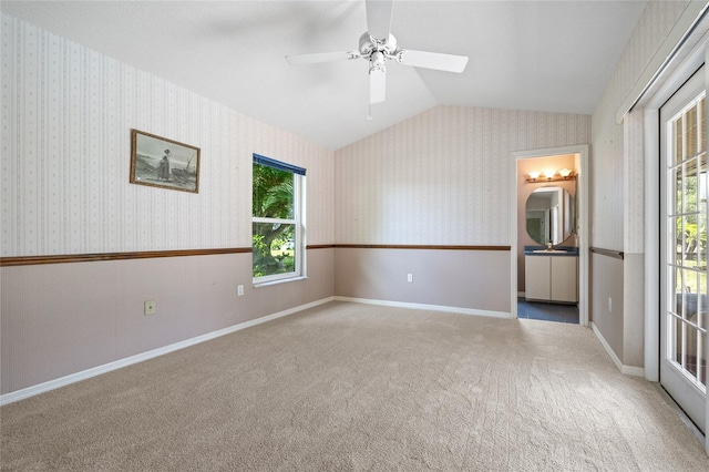 501 Fairmont Ter, Port Charlotte, FL 33954 - unfurnished room featuring lofted ceiling, carpet floors, wallpapered walls, a ceiling fan, and baseboards