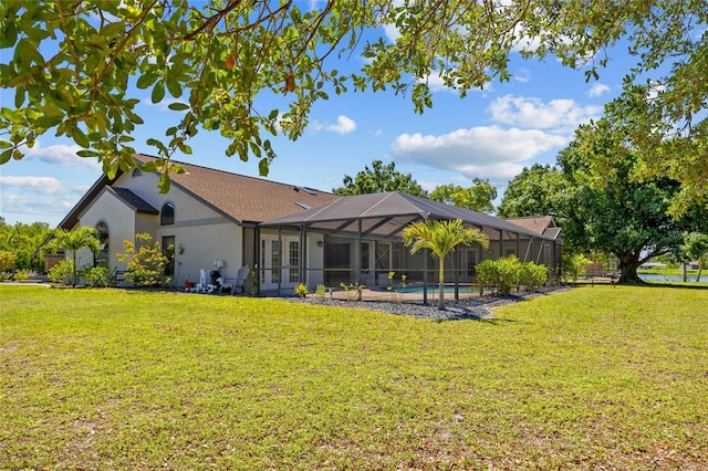 501 Fairmont Ter, Port Charlotte, FL 33954 - rear view of house featuring french doors, a lawn, stucco siding, a lanai, and an outdoor pool