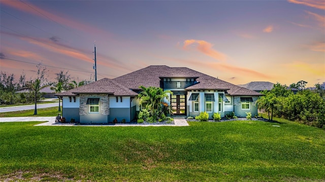 view of front of property featuring french doors, a front yard, and stucco siding