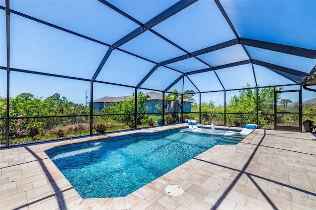 outdoor pool with a patio and glass enclosure