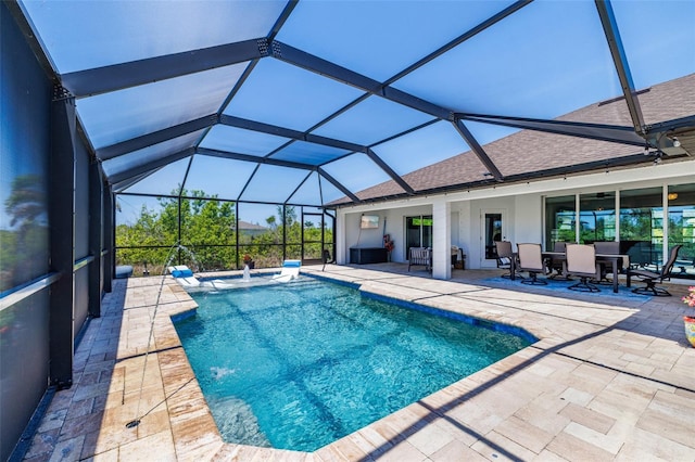 outdoor pool featuring a patio area, glass enclosure, and outdoor dining area