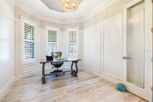office space featuring a decorative wall, a chandelier, and light wood finished floors