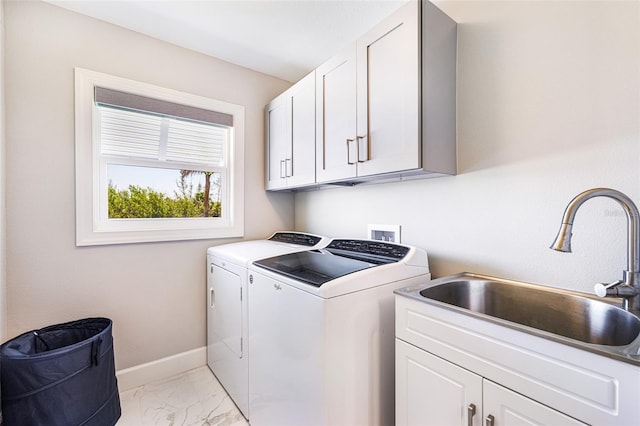 laundry area with cabinet space, independent washer and dryer, baseboards, and light marble finish flooring