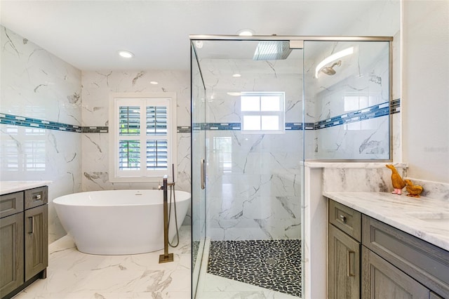 bathroom featuring vanity, a marble finish shower, a soaking tub, and marble tiled floors