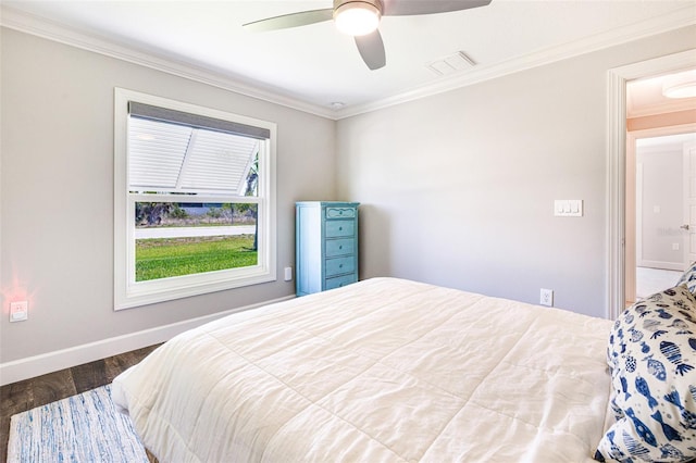 bedroom featuring crown molding, wood finished floors, baseboards, and ceiling fan