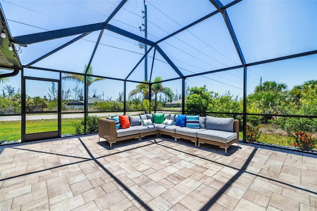 view of patio featuring outdoor lounge area and glass enclosure