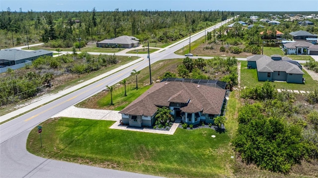 aerial view of residential area featuring a heavily wooded area
