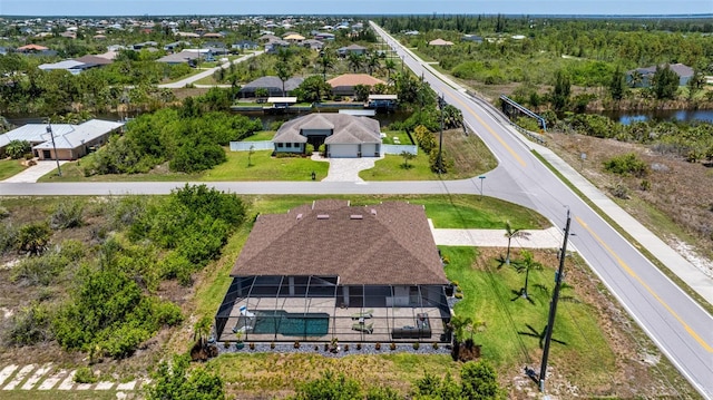 aerial view of property and surrounding area with a nearby body of water