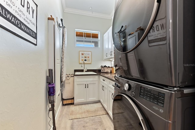 329 W Grace St, Punta Gorda, FL 33950 - laundry room with estacked washer and dryer, cabinet space, light wood-type flooring, and ornamental molding