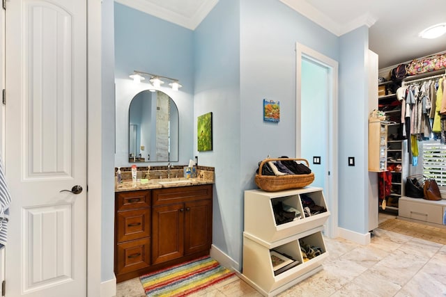 329 W Grace St, Punta Gorda, FL 33950 - bathroom featuring ornamental molding, vanity, a spacious closet, and baseboards