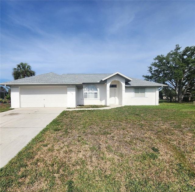 4390 Wischamper St, Port Charlotte, FL 33948 - ranch-style home with driveway, an attached garage, a front yard, and stucco siding